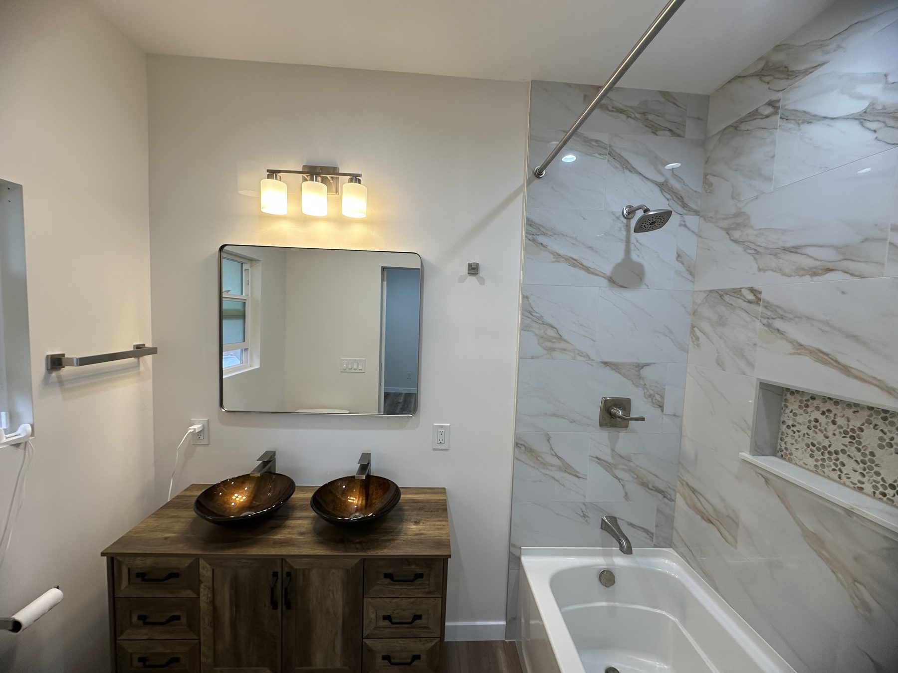 Bathroom with double vessel-sink vanity and tiled tub at 1148 S Rimpau Blvd